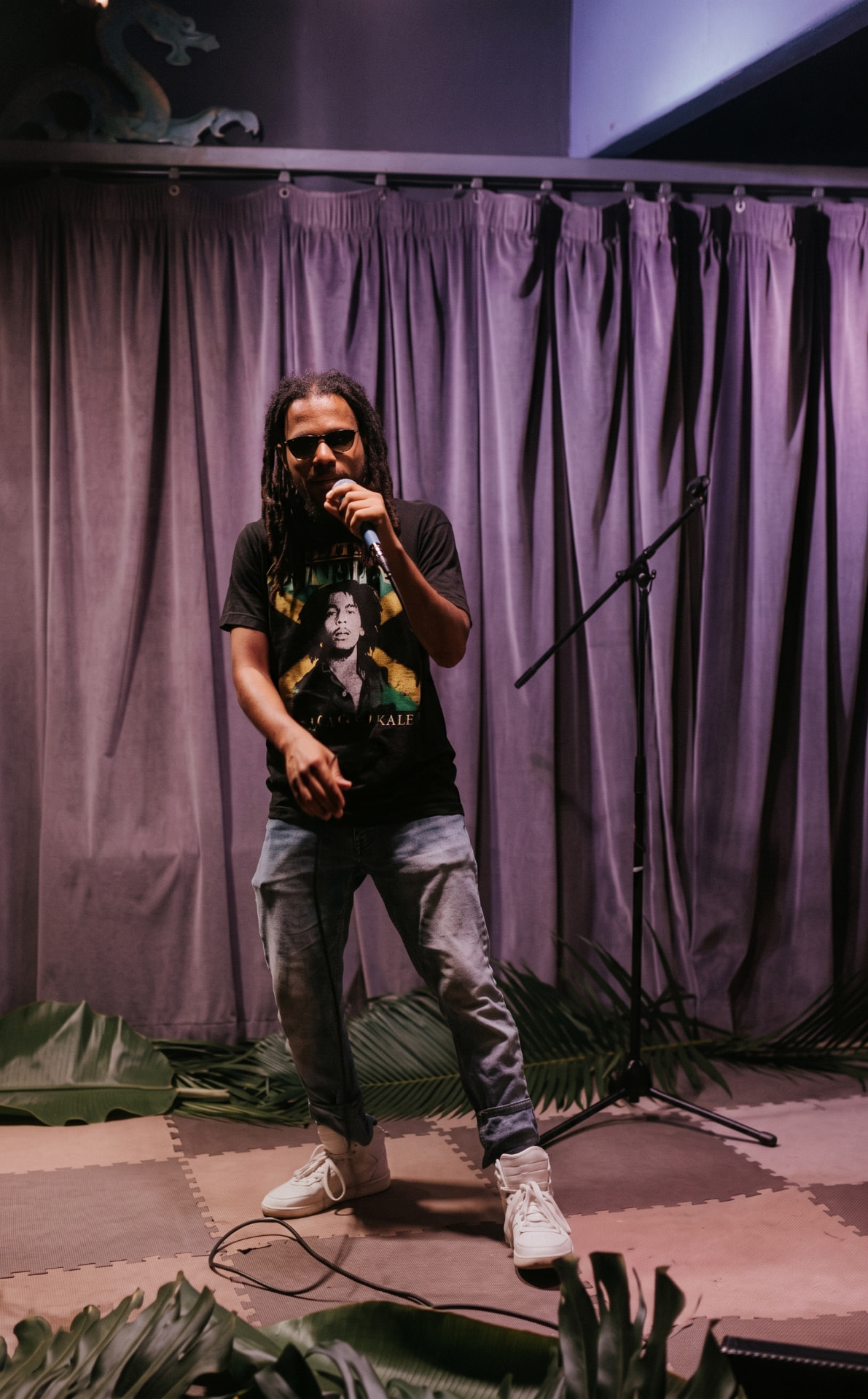 Shane Love performing live on stage with a microphone